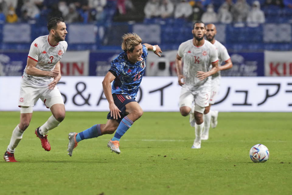 Ritsu Doan of Japan runs for the ball during the match between Japan and Tunisia at the Kirin Cup soccer tournament in Suita, west Japan, Tuesday, June 14, 2022. (AP Photo/Eugene Hoshiko)