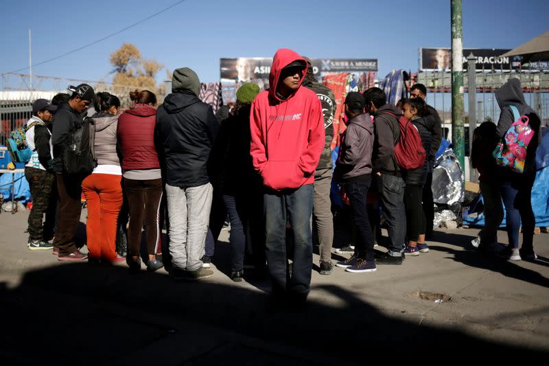 Mexican asylum seekers, who are camping near the Paso del Norte international border crossing bridge while waiting to apply for asylum to the U.S., gather outside their tents in Ciudad Juarez