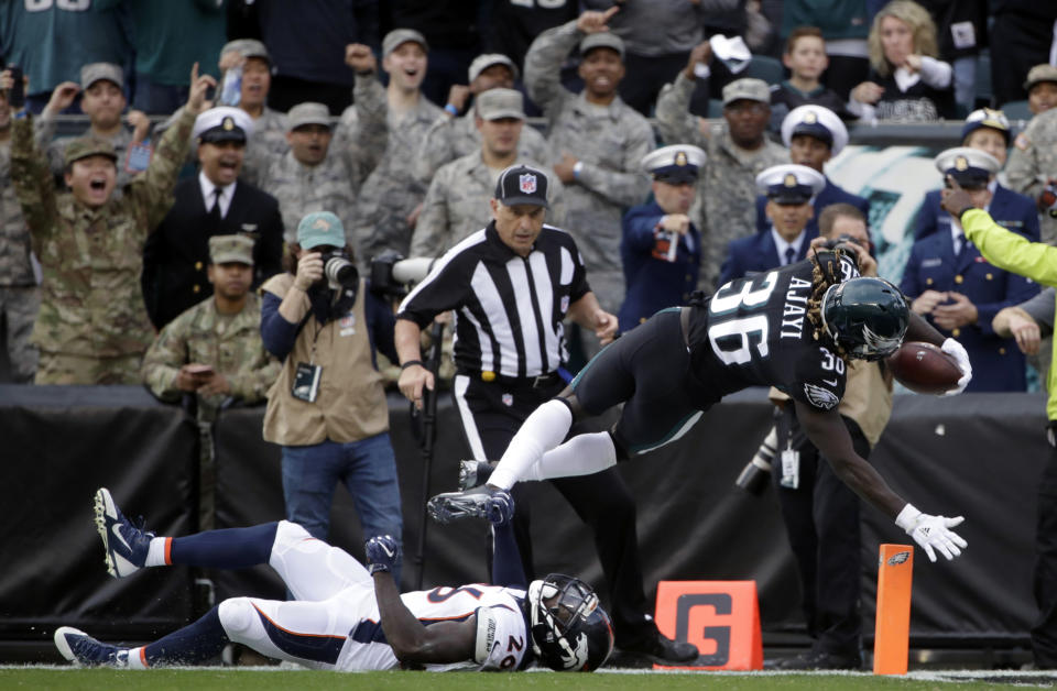 <p>Philadelphia Eagles’ Jay Ajayi (36) scores a touchdown over Denver Broncos’ Darian Stewart (26) during the first half of an NFL football game, Sunday, Nov. 5, 2017, in Philadelphia. (AP Photo/Matt Rourke) </p>