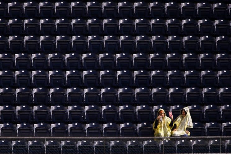 A baseball fan takes a selfie in the right field grandstand as a rain delay is called during the sixth inning of a baseball game between the Pittsburgh Pirates and the Chicago Cubs at PNC Park in Pittsburgh, Thursday, Sept. 29, 2016. (AP Photo/Gene J. Puskar)