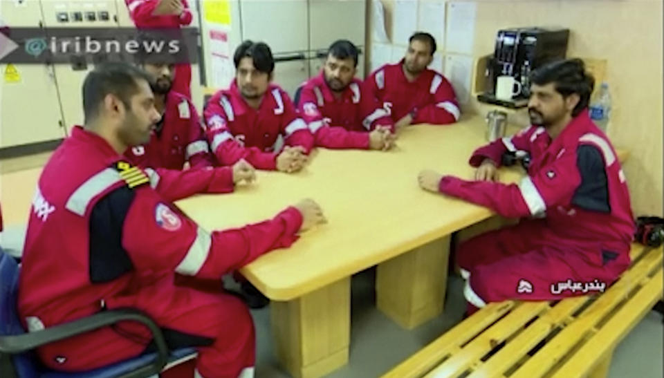 In this photo released by state-run IRIB News Agency, which aired on Monday, July 22, 2019, shows various crew members of the British-flagged tanker Stena Impero, that was seized by Tehran in the Strait of Hormuz on Friday, during a meeting. The Associated Press cannot independently verify the condition of the crew members, but in the video they looked to be in good health and it didn't appear as though they were being filmed under duress. (IRIB News Agency via AP)