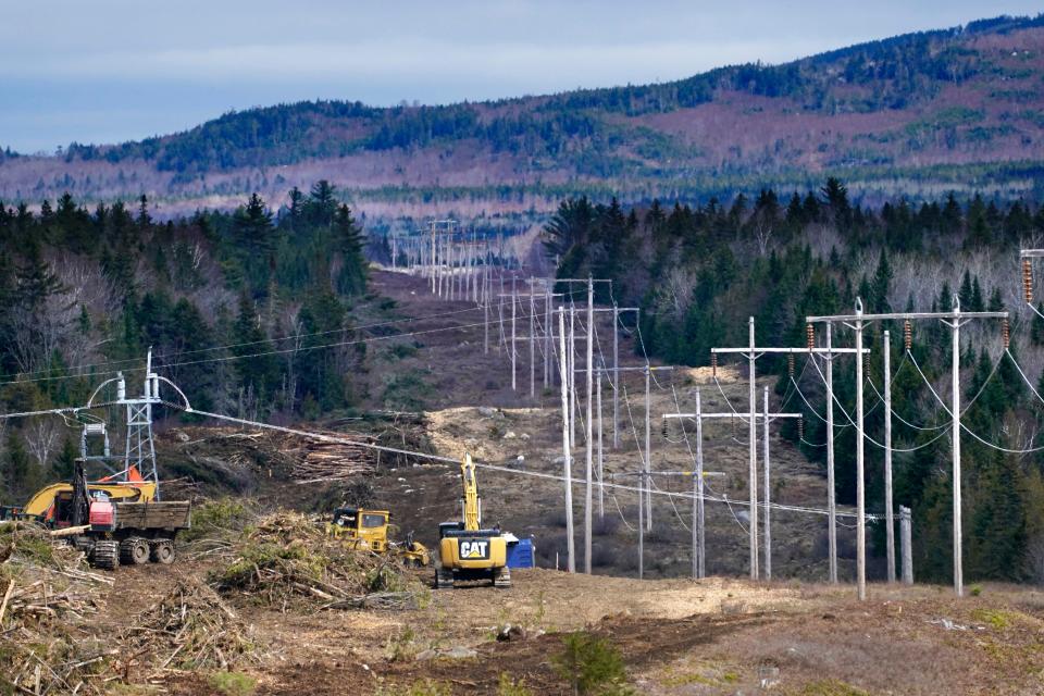 Heavy machinery is used to cut trees to widen an existing Central Maine Power power line corridor to make way for new utility poles, April 26, 2021, near Bingham, Maine.  A Maine jury concluded on Thursday that developers have a constitutional right to proceed with a $1 billion transmission project, despite being rebuked by state voters in a referendum.