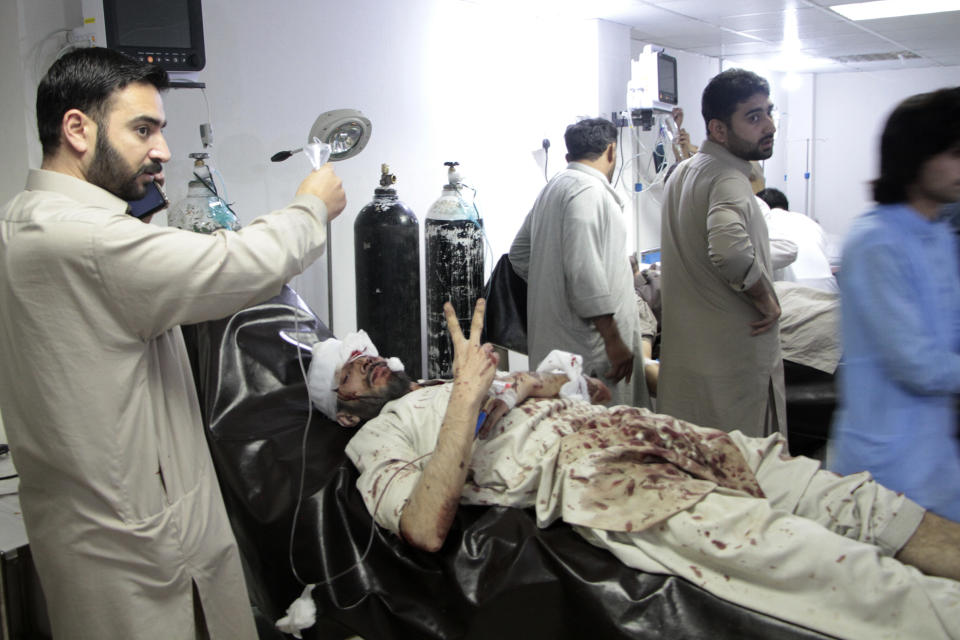 An injured victim of bomb blast is treated at a hospital, in Saidu Sharif, main town of Pakistan's Swat Valley, Monday, April 24, 2023. Two explosions Monday at a counterterrorism police facility in northwest Pakistan killed few people and wounded dozens, police said. (AP Photo/Naveed Ali)