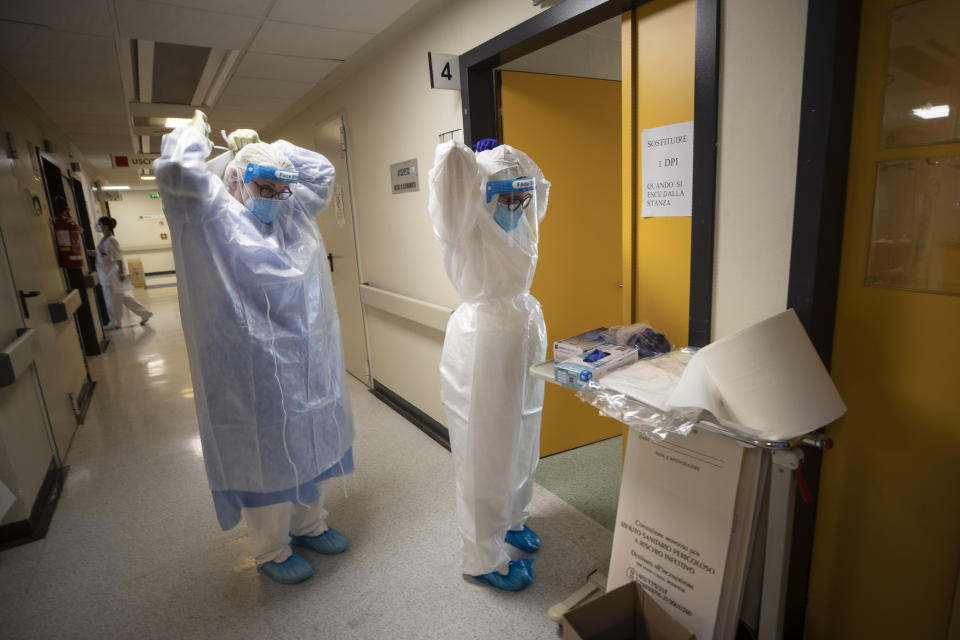 Nurses prepare to enter the ICU at the Mellino Mellini hospital in Chiari, northern Italy, Monday, March 8, 2021. The 160-bed hospital in the Po River Valley town of Chiari has no more beds for patients stricken with the highly contagious variant of COVID-19 first identified in Britain, and which now has put hospitals in Italy’s northern Brescia province on high alert. (AP Photo/Luca Bruno)