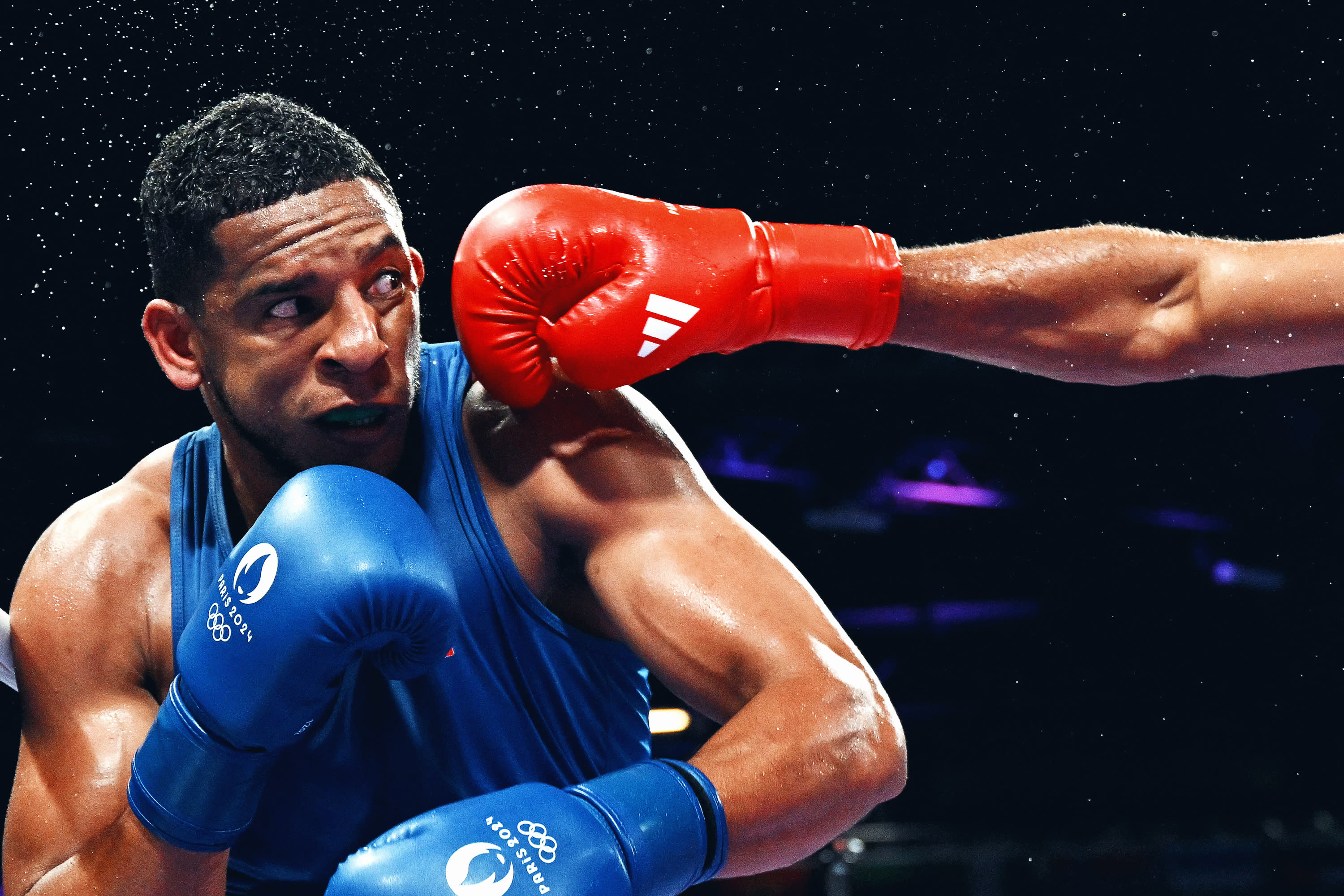 Spain's Enmanuel Reyes Pla is punched by Belgium's Victor Schelstraete in the men's 92kg quarter-final boxing match during the Paris 2024 Olympic Games at the North Paris Arena, in Villepinte on August 1, 2024. (Photo by MOHD RASFAN / AFP) (Photo by MOHD RASFAN/AFP via Getty Images)
