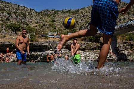 People cool off in the Cijevna river near Tuzi as a heatwave hits Montenegro, August 4, 2017. REUTERS/Stevo Vasiljevic