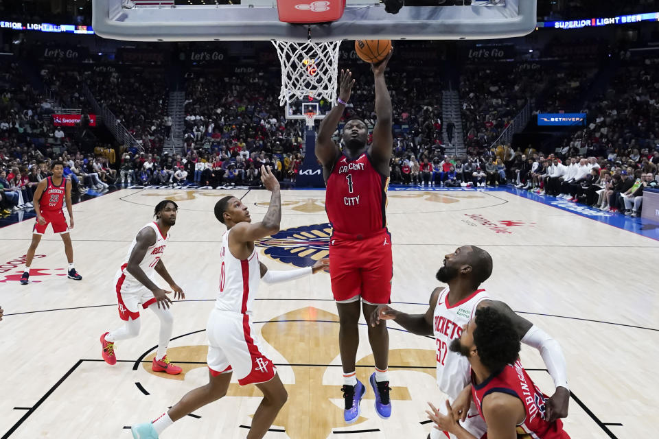New Orleans Pelicans forward Zion Williamson (1) shoots against Houston Rockets forward Jabari Smith Jr. in the first half of an NBA basketball game in New Orleans, Saturday, Dec. 23, 2023. (AP Photo/Gerald Herbert)