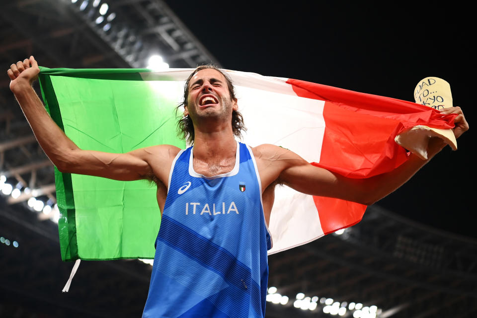 <p>TOKYO, JAPAN - AUGUST 01: Gianmarco Tamberi of Team Italy reacts after winning the gold medal in the men's High Jump on day nine of the Tokyo 2020 Olympic Games at Olympic Stadium on August 01, 2021 in Tokyo, Japan. (Photo by Matthias Hangst/Getty Images)</p> 