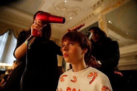 A model is groomed before the Jasper Conran catwalk show during London Fashion Week in London, Britain February 18, 2017. REUTERS/Neil Hall