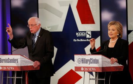 Democratic U.S. presidential candidates former Secretary of State Hillary Clinton and Senator Bernie Sanders discuss a point during the second official 2016 U.S. Democratic presidential candidates debate in Des Moines, Iowa, November 14, 2015. REUTERS/Jim Young