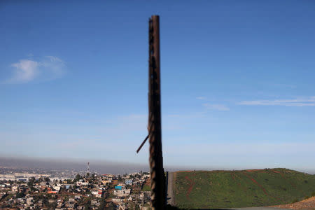 A section of the border fence separating Mexico (L) and the United States is seen on the outskirts of Tijuana, Mexico. REUTERS/Edgard Garrido