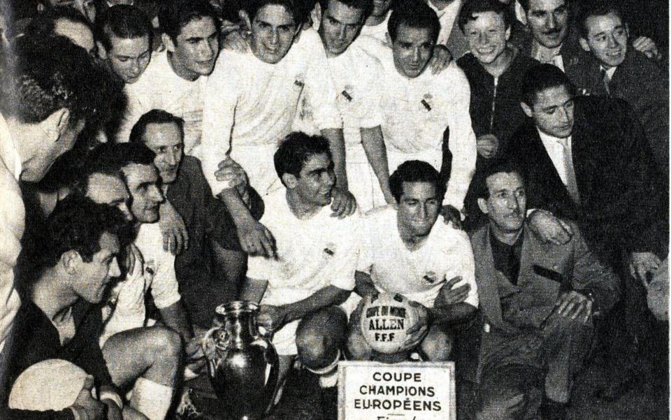 The victorious Real Madrid side celebrate with the trophy after the game, the first European Cup Final