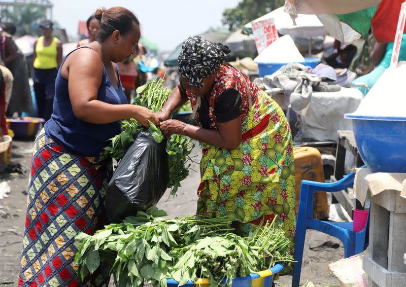 FILE PHOTO: A Congolese woman buys groceries at an open air market, amid concerns about the spread of coronavirus disease (COVID-19) in Kinshasa
