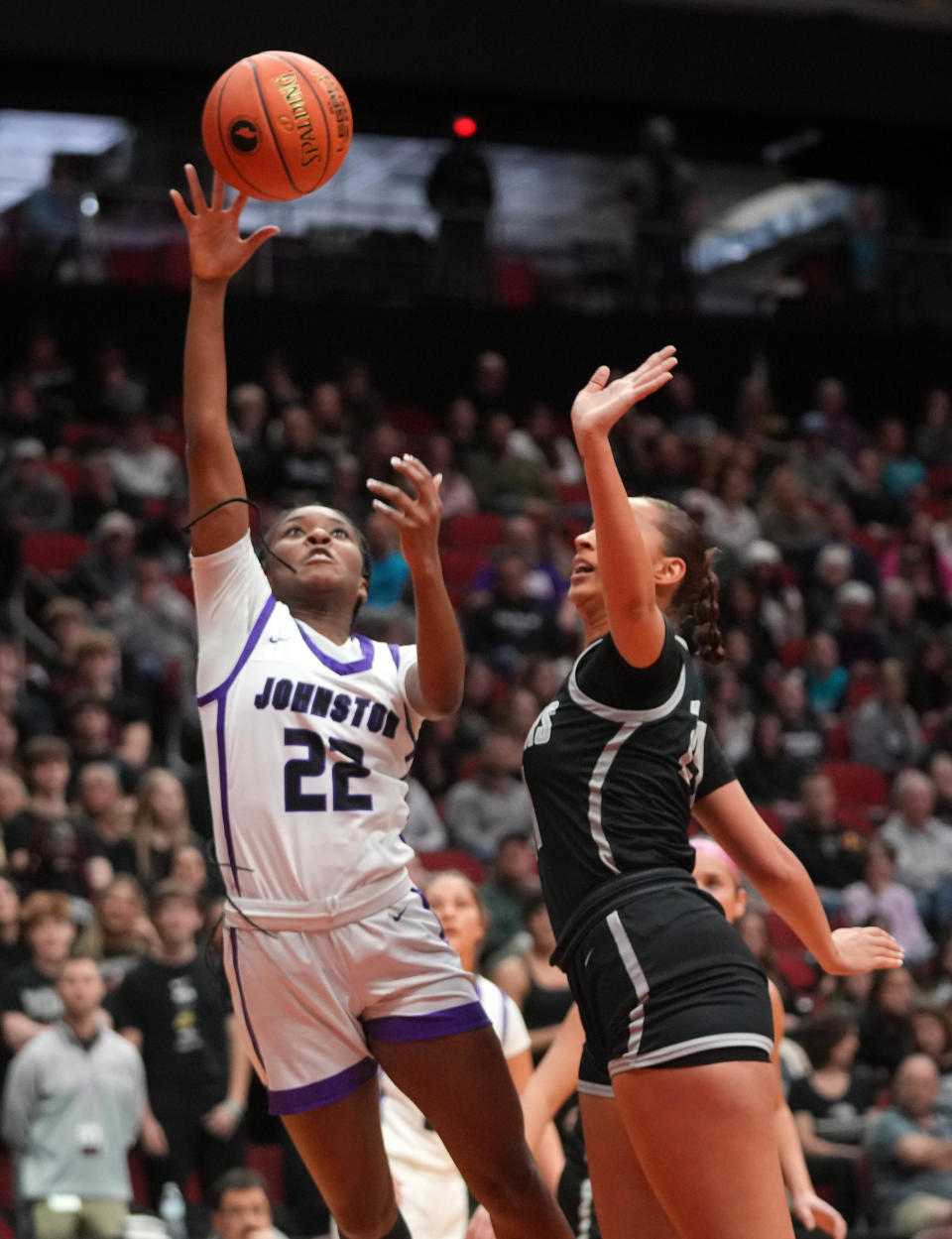 Johnston's Aaliyah Riley (22) drives to the basket during their 5A semifinal matchup against Ankeny Centennial.