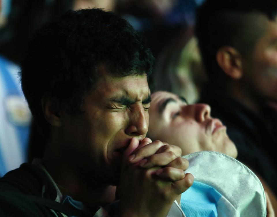 Argentina fan reacts after Argentina lost to Germany in 2014 World Cup final soccer match in Brazil, at public square viewing area in Buenos Aires
