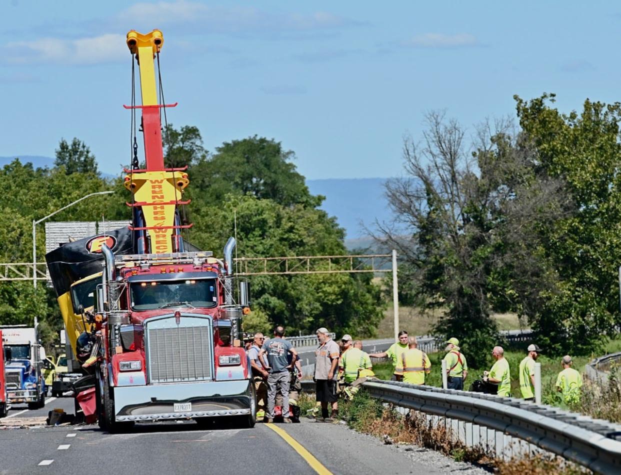 A tow truck works at the scene of a fatal crash that involved four tractor-trailers and two passenger vehicles Friday morning on Interstate 81 north of Hagerstown. At least one person was killed and multiple people were injured.