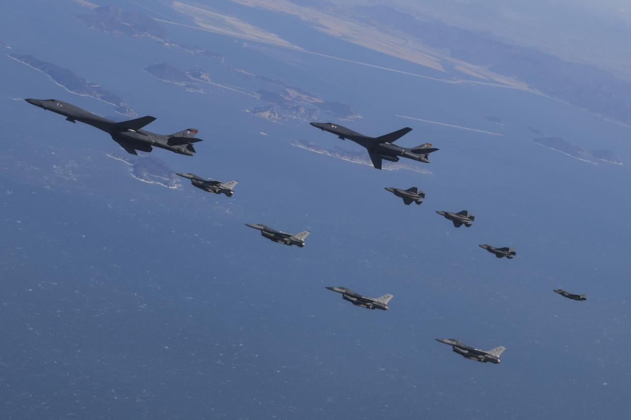 In this photo provided by South Korea Defense Ministry, U.S. Air Force B-1B bombers fly in formation with South Korea's Air Force F-35A fighter jets and U.S. Air Force F-16 fighter jets over the South Korea Peninsula during a joint air drill in South Korea, Sunday, Feb. 19, 2023. (South Korea Defense Ministry via AP)
