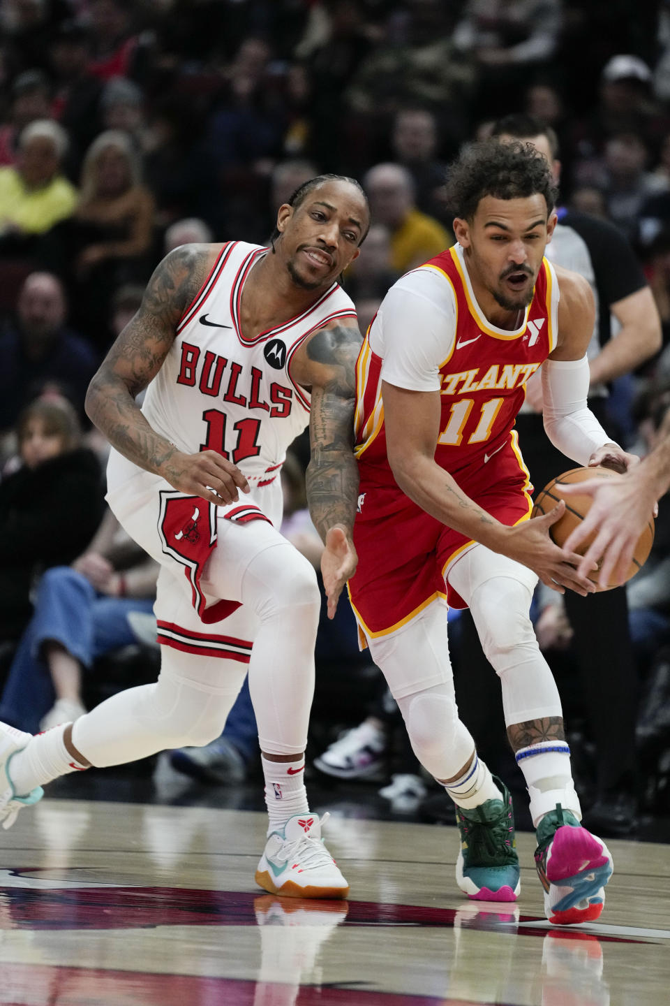 Chicago Bulls forward DeMar DeRozan, left, defends against Atlanta Hawks guard Trae Young during the first half of an NBA basketball game Tuesday, Dec. 26, 2023, in Chicago. (AP Photo/Erin Hooley)