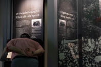 A visitor looks closely at the original copy of the Rev. Martin Luther King Jr.'s "I Have a Dream" speech on display at the National Museum of African American History and Culture in Washington, Friday, Aug. 18, 2023. (AP Photo/Stephanie Scarbrough)