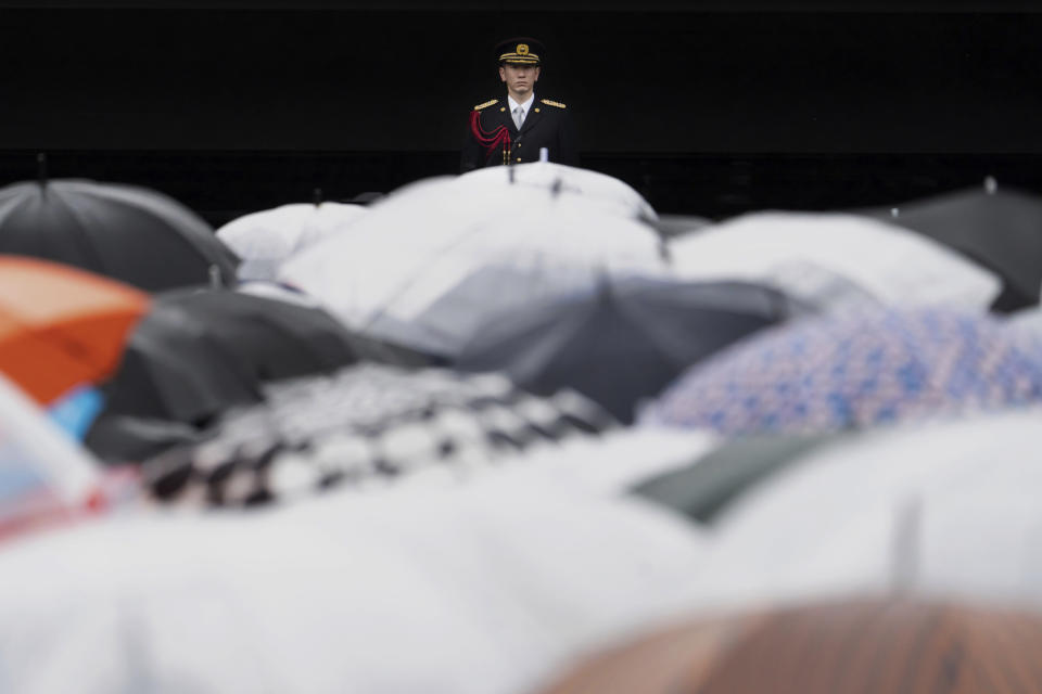 A member of the Imperial Guard stands before Japan's Emperor Naruhito appears on the balcony of the Imperial Palace for his birthday in Tokyo on Friday, Feb. 23, 2024. Emperor Naruhito turns 64 on Friday. (Tomohiro Ohsumi/Pool Photo via AP)