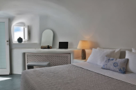 <p>The home’s traditional cave-curved, pearl-white walls were maintained as part of the renovations. (Airbnb) </p>