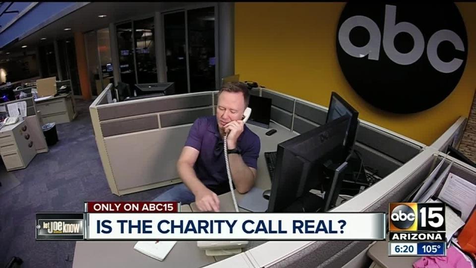 A newsperson on the phone with the words, "Is the charity call real?"