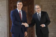 Spanish Prime Minister Pedro Sanchez, left, shakes hands with Catalan regional President Quim Torra at the Palace of the Generalitat, the headquarter of the Government of Catalonia, in Barcelona, Thursday, Feb. 6, 2020. (AP Photo/Emilio Morenatti)