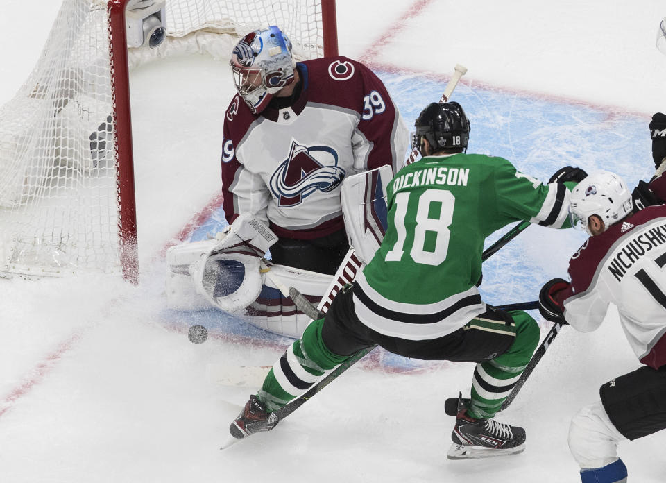 Dallas Stars' Jason Dickinson (18) is stopped by Colorado Avalanche goalie Pavel Francouz (39) during the third period of Game 3 of an NHL hockey second-round playoff series, Wednesday, Aug. 26, 2020, in Edmonton, Alberta. (Jason Franson/The Canadian Press via AP)