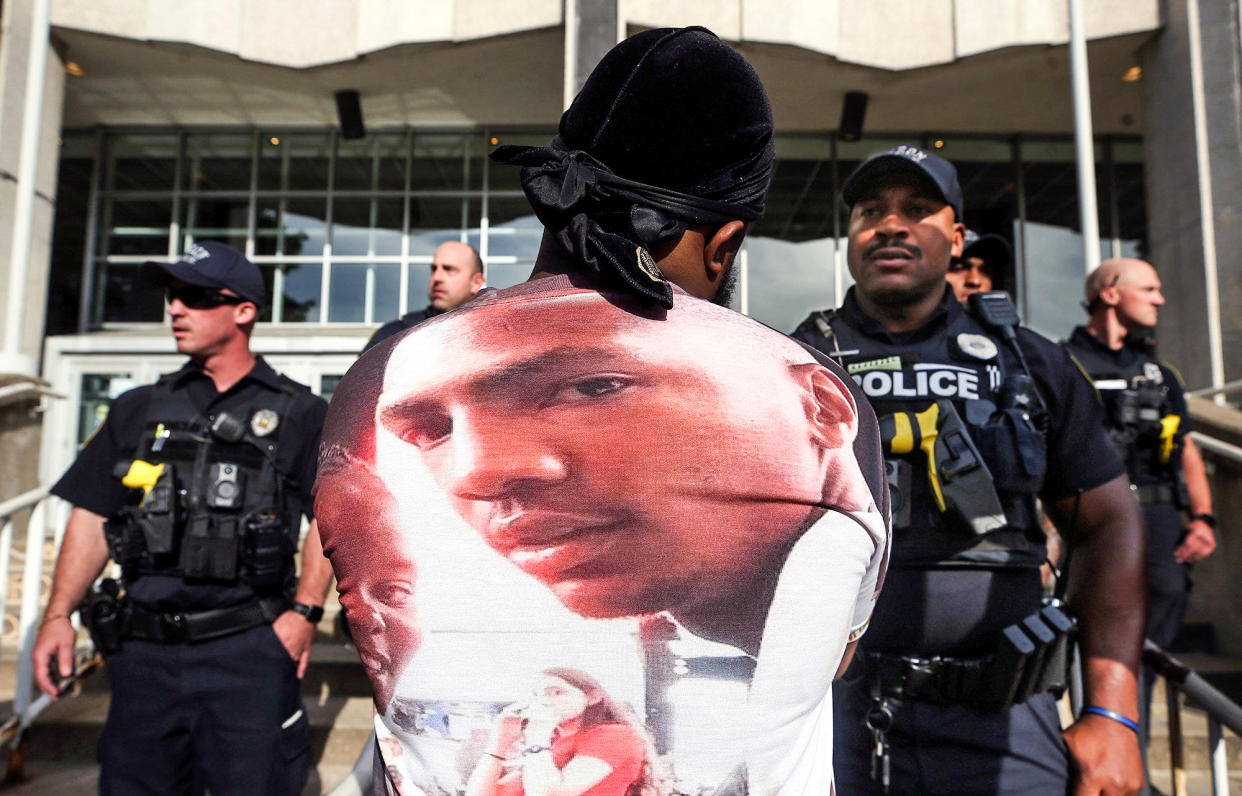 A protester stares down an Akron police officer outside the Harold K. Stubbs Justice Center during a protest on July 2, 2022, in Akron, Ohio, after Akron police officers shot and killed Jayland Walker earlier. (Jeff Lange / Akron Beacon Journal via USA TODAY Network)
