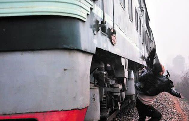 Xiao Li has her narrow escape as the train passes by. Photo: Chengsu Evening News