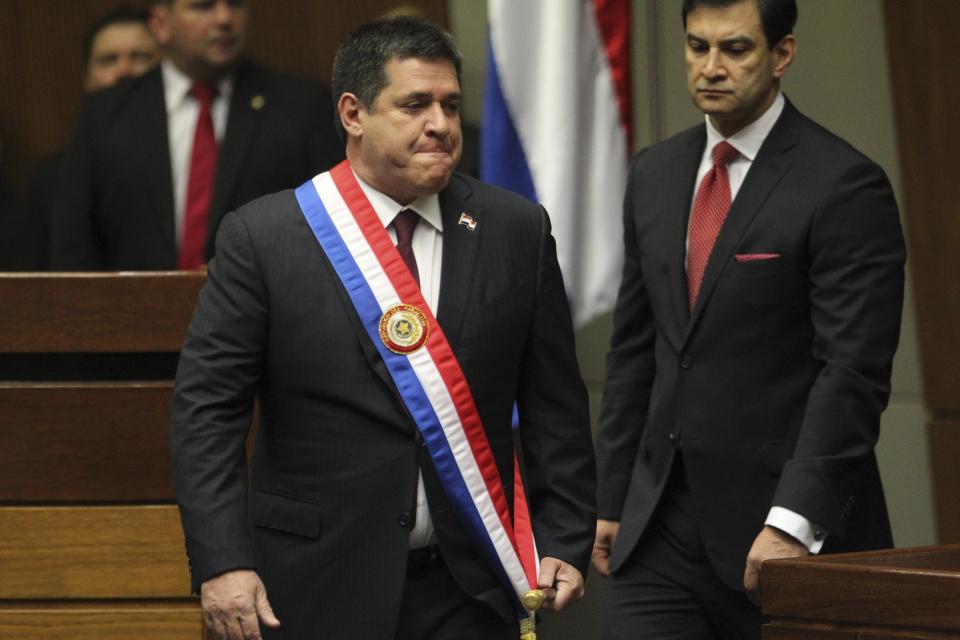 FILE - Paraguay's outgoing President Horacio Cartes arrives in Congress to pass on the presidential sash and the baton to the incoming president, in Asuncion, Paraguay, Aug. 15, 2018. The United States has sanctioned Cartes and current Vice President Hugo Velazquez Moreno, unveiling accusations on Thursday, Jan. 26, 2023, that the two participated in widespread schemes of corruption and have ties to members of a terrorist organization. (AP Photo/Marta Escurra, File)