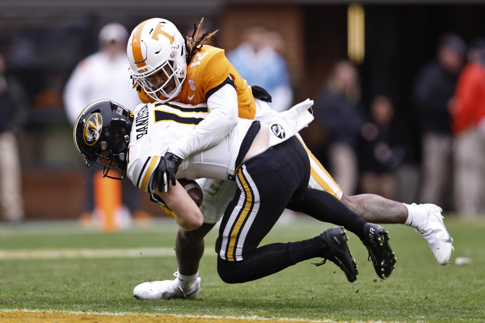 Missouri wide receiver Barrett Banister (11) is tackled by Tennessee defensive back Tamarion McDonald (12) during the second half of an NCAA college football game Saturday, Nov. 12, 2022, in Knoxville, Tenn. (AP Photo/Wade Payne)