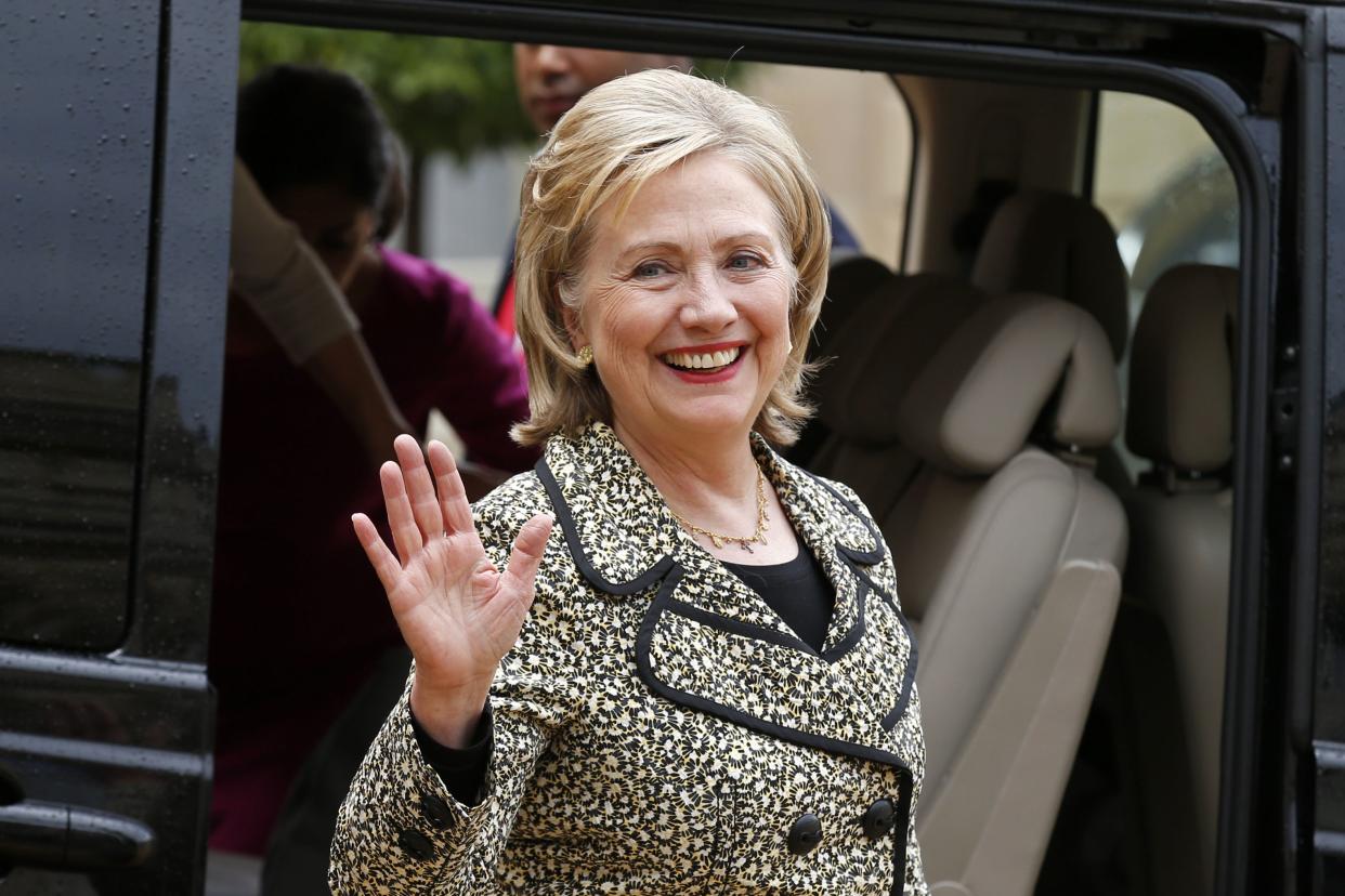 Former U.S. Secretary of State Hillary Clinton waves after a meeting at the Elysee Palace in Paris.