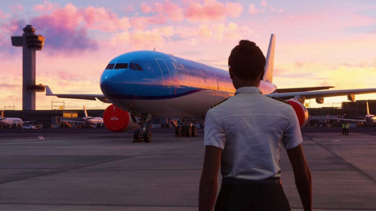  A pilot looks out over an airplane at sunset. 