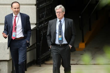 FILE PHOTO: White House legal counsel Flood, walking with Associate Counsel Morrell, exits the Eisenhower Executive Office Building on the White House campus in Washington