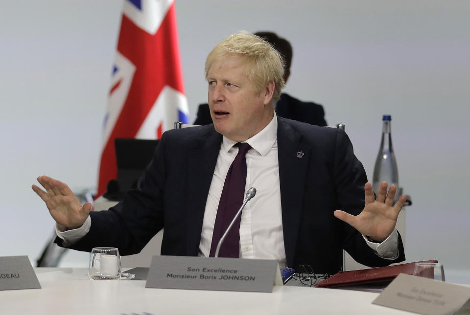 Britain's Prime Minister Boris Johnson gestures ahead of a working session on World Economy and Trade on the second day of the G-7 summit in Biarritz, France Sunday, Aug. 25, 2019. (AP Photo/Markus Schreiber)