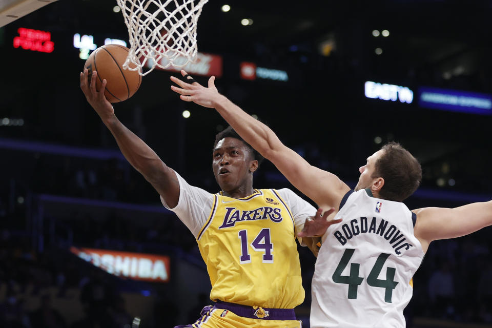 Los Angeles Lakers forward Stanley Johnson (14) goes to basket under pressure from Utah Jazz forward Bojan Bogdanovic (44) during the second half of an NBA basketball game in Los Angeles, Monday, Jan. 17, 2022. The Lakers won 101-95. (AP Photo/Ringo H.W. Chiu)