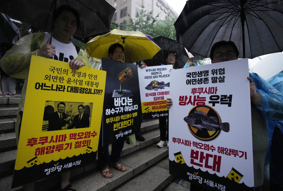 Protesters attend a rally against the Japanese government's decision to release treated radioactive wastewater from the Fukushima nuclear power plant, in Seoul, South Korea, Tuesday, July 4, 2023. The head of the U.N. nuclear agency is in Japan to meet with government leaders Tuesday and to see final preparations for the release of treated radioactive wastewater into the sea from the damaged Fukushima nuclear plant, on a visit Japan hopes will give credibility to the contentious plan. The letters read, "Oppose to release treated radioactive water from the Fukushima." (AP Photo/Ahn Young-joon)