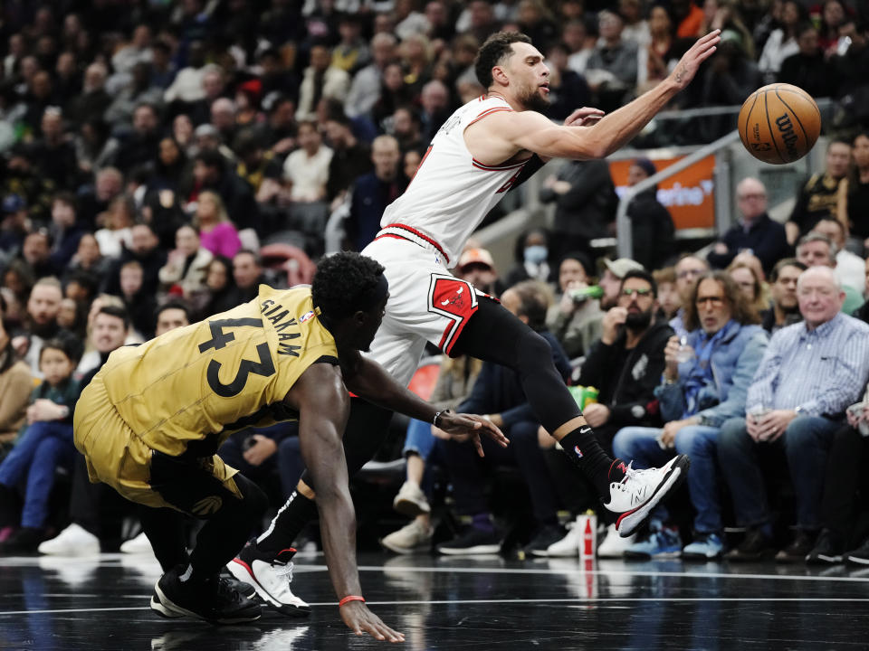 Toronto Raptors' Pascal Siakam (43) stumbles as Chicago Bulls' Zach LaVine (8) chases the ball during the first half of an NBA basketball In-Season Tournament game Friday, Nov. 24, 2023, in Toronto. (Frank Gunn/The Canadian Press via AP)