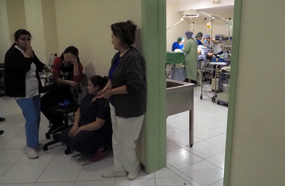 Medical workers take refuge in a basement of a hospital as doctors perform surgery during shelling by Azerbaijan's artillery in Stepanakert, the separatist region of Nagorno-Karabakh, Wednesday, Oct. 28, 2020. Nagorno-Karabakh officials said Azerbaijani forces hit Stepanakert, the region's capital, and the nearby town of Shushi with the Smerch long-range multiple rocket systems, killing one civilian and wounding two more. (AP Photo)