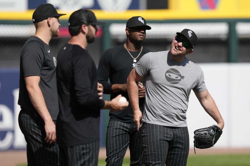 Chicago White Sox pitcher Liam Hendriks, right, laughs with teammates before a baseball game against the Los Angeles Angels, Monday, May 29, 2023, in Chicago. The White Sox returned Hendriks from his injury rehabilitation assignment with Triple-A Charlotte and reinstated him from the 15-day injured list Monday. (AP Photo/Charles Rex Arbogast)