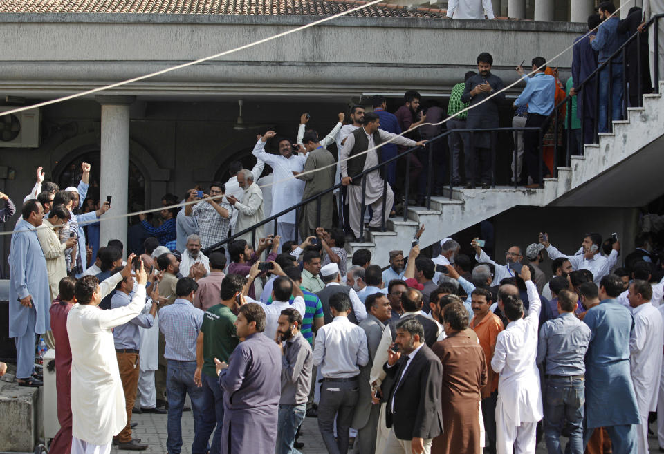 Supporters of former Pakistani Prime Minister Nawaz Sharif shout slogans and celebrate after a court ruling, outside the Islamabad High Court in Islamabad, Pakistan, Wednesday, Sept. 19, 2018. The Pakistani court suspended the prison sentences of Sharif, his daughter and son-in-law on Wednesday and set them free on bail pending their appeal hearings. The court made the decision on the corruption case handed down to the Sharifs by an anti-graft tribunal earlier this year. (AP Photo/Anjum Naveed)