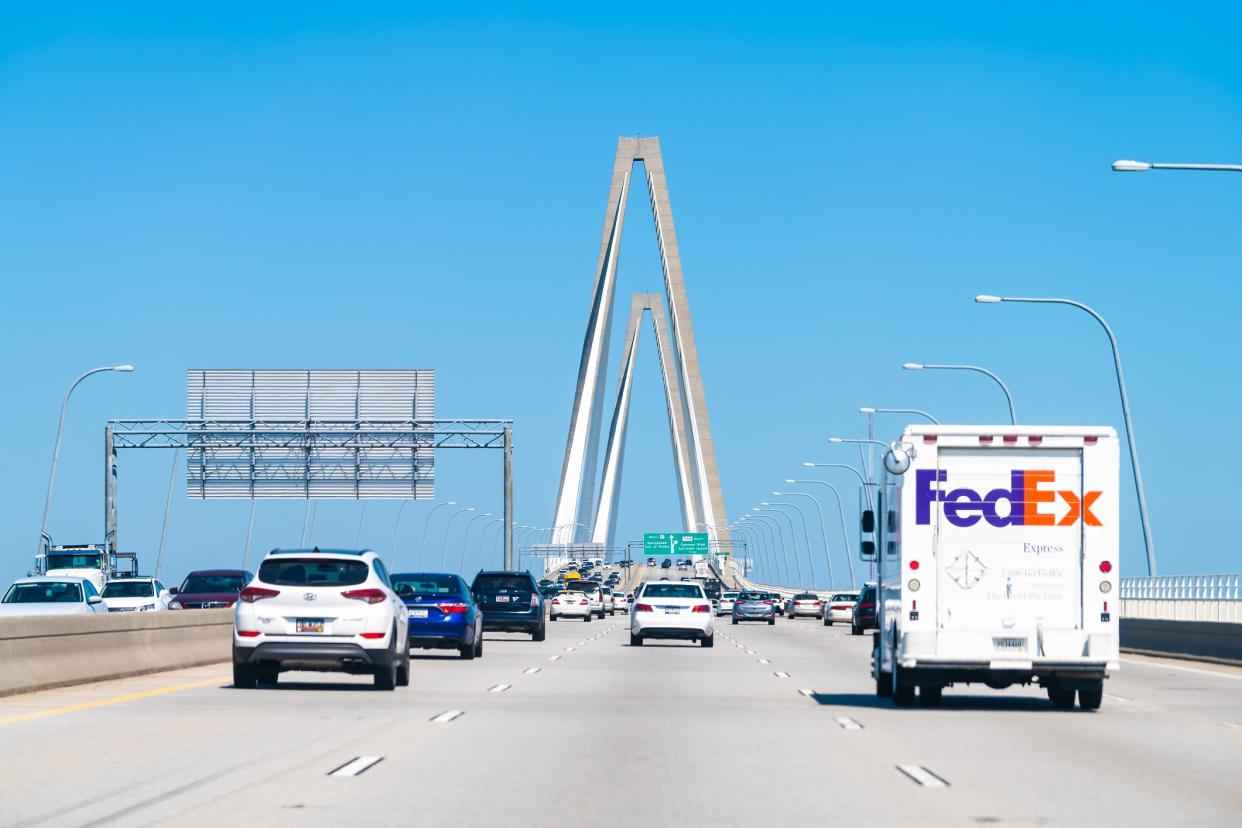 Charleston, USA - May 11, 2018: South Carolina Arthur Ravenel Jr. Cooper river cable-stayed triangular arches bridge with cars on state road 17 with traffic cars, Federal express truck van