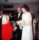 <p>Receiving a bouquet of flowers from Heather Ripley, one of the child stars of <em>Chitty Chitty Bang Bang</em> at the film's premiere.</p>