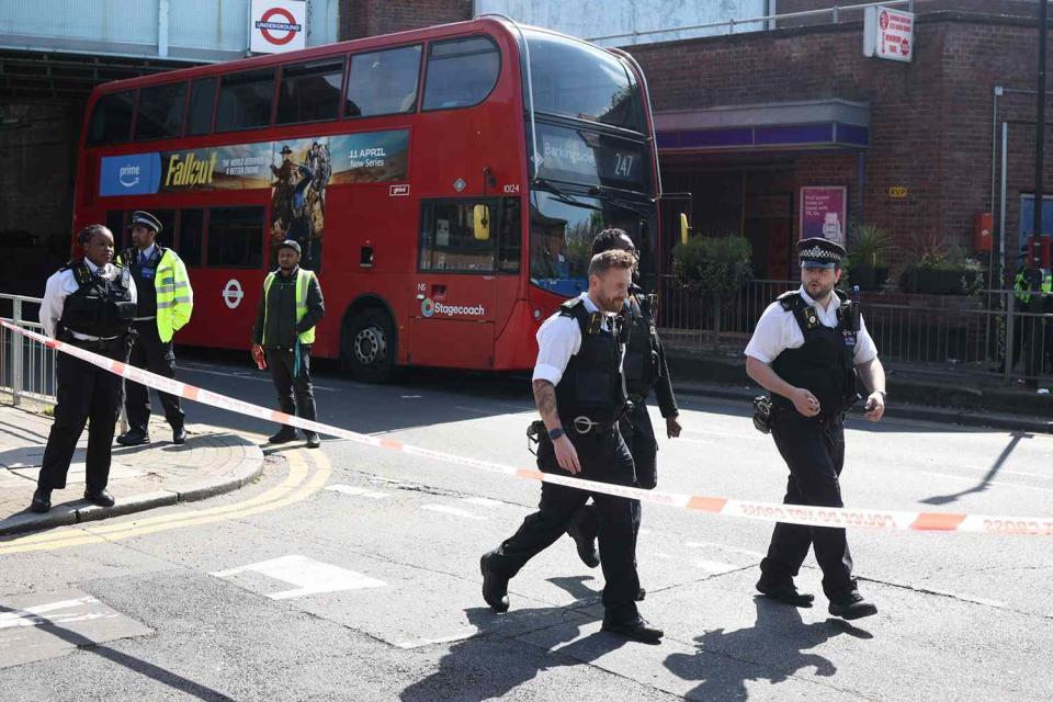 <p>Marcin Nowak/LNP/Shutterstock</p> Police stand guard outside Hainault Underground station in London.