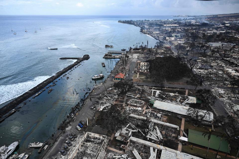 An aerial image taken on August 10, 2023 shows destroyed homes and buildings burned to the ground in the historic Lahaina in the aftermath of wildfires in western Maui in Lahaina, Hawaii. At least 36 people have died after a fast-moving wildfire turned Lahaina to ashes, officials said August 9, 2023 as visitors asked to leave the island of Maui found themselves stranded at the airport. The fires began burning early August 8, scorching thousands of acres and putting homes, businesses and 35,000 lives at risk on Maui, the Hawaii Emergency Management Agency said in a statement. (Photo by Patrick T. Fallon / AFP) (Photo by PATRICK T. FALLON/AFP via Getty Images)