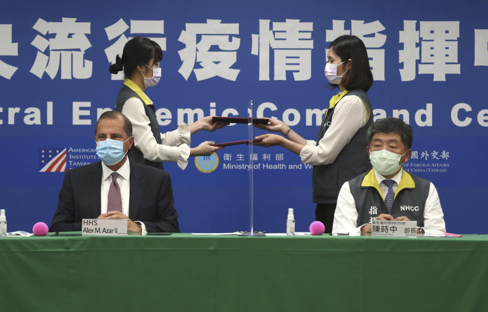 U.S. Health and Human Services Secretary Alex Azar, seated left, and Taiwanese Minister of Health and Welfare Chen Shih-chung sign a contract during a signing ceremony for a memorandum of understanding at the Central Epidemic Command Center in Taipei, Taiwan, Monday, Aug. 10, 2020. Azar arrived in Taiwan on Sunday in the highest-level visit by an American Cabinet official since the break in formal diplomatic relations between Washington and Taipei in 1979. (AP Photo/Chiang Ying-ying)