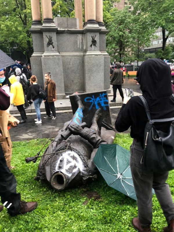 Statue of first Canadian PM Macdonald is seen on the ground after it was pulled down during a protest against racial inequality, in Montreal, Quebec