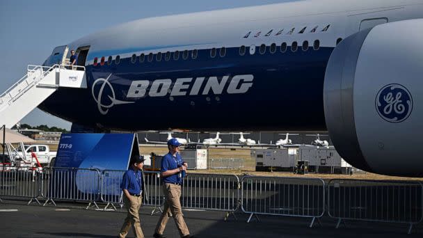 PHOTO: Members of staff walk past a Boeing 777-9 displayed during the Farnborough Airshow, in Farnborough, U.K., July 18, 2022. (Justin Tallis/AFP via Getty Images, FILE)