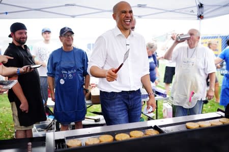 U.S. Senator Booker smiles while frying veggie burgers at the Polk County Democrats' Steak Fry in Des Moines